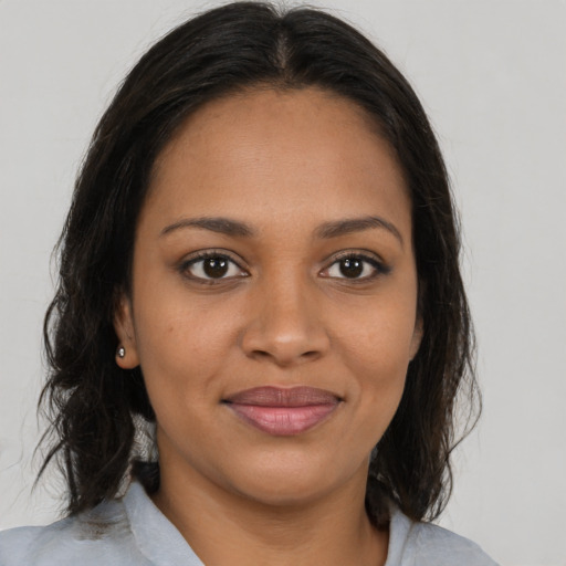 Joyful black young-adult female with medium  brown hair and brown eyes