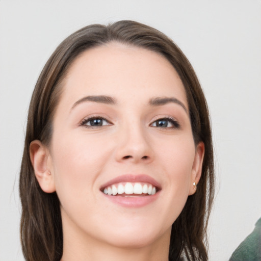 Joyful white young-adult female with long  brown hair and grey eyes