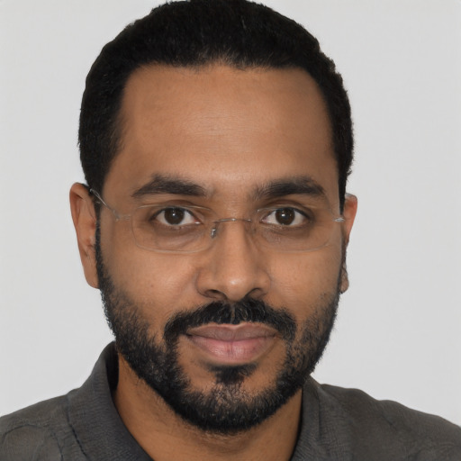 Joyful black young-adult male with short  black hair and brown eyes