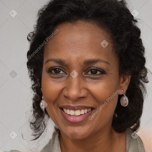 Joyful black adult female with long  brown hair and brown eyes