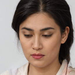 Joyful asian young-adult female with medium  brown hair and brown eyes