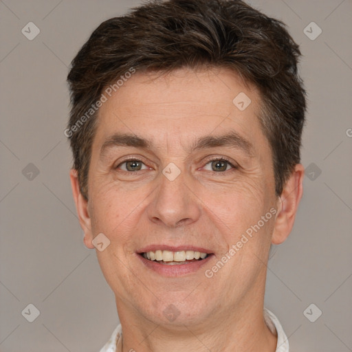 Joyful white adult male with short  brown hair and brown eyes