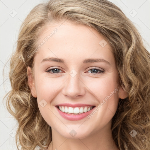 Joyful white young-adult female with long  brown hair and green eyes