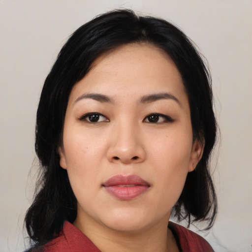 Joyful asian young-adult female with medium  black hair and brown eyes