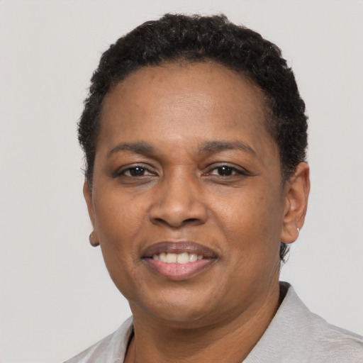 Joyful black adult female with short  black hair and brown eyes