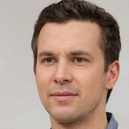 Joyful white adult male with short  brown hair and brown eyes