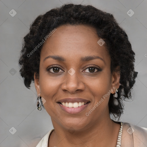 Joyful black young-adult female with long  black hair and brown eyes