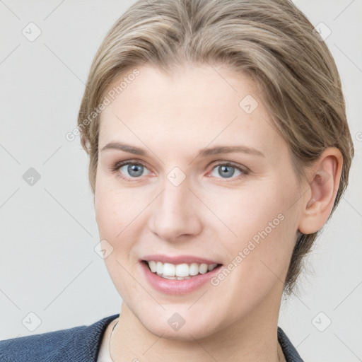 Joyful white young-adult female with medium  brown hair and blue eyes