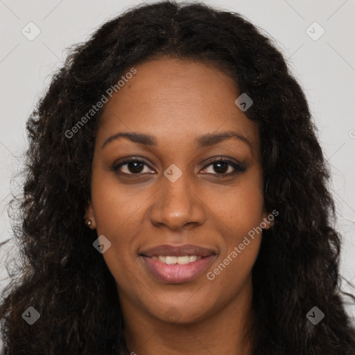 Joyful black young-adult female with long  brown hair and brown eyes