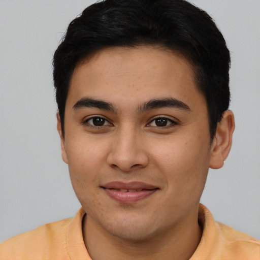 Joyful asian young-adult male with short  brown hair and brown eyes