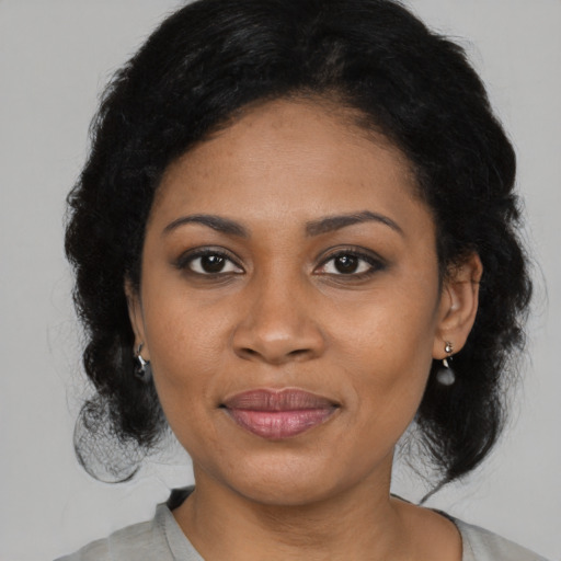 Joyful latino young-adult female with medium  black hair and brown eyes