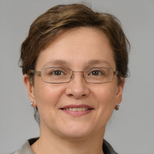 Joyful white adult female with short  brown hair and green eyes