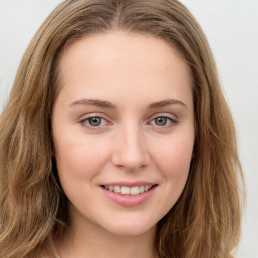 Joyful white young-adult female with long  brown hair and green eyes