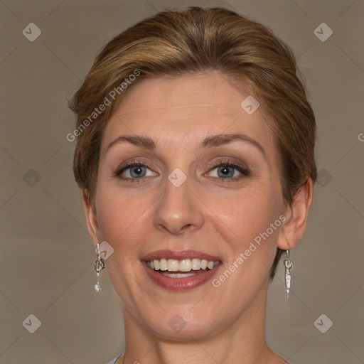 Joyful white adult female with medium  brown hair and grey eyes