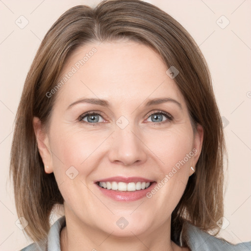 Joyful white adult female with medium  brown hair and grey eyes