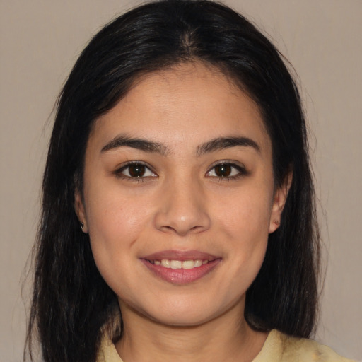 Joyful asian young-adult female with long  brown hair and brown eyes