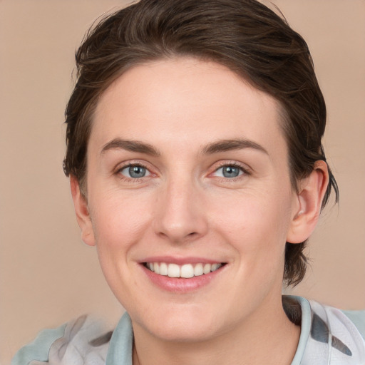 Joyful white young-adult female with medium  brown hair and grey eyes