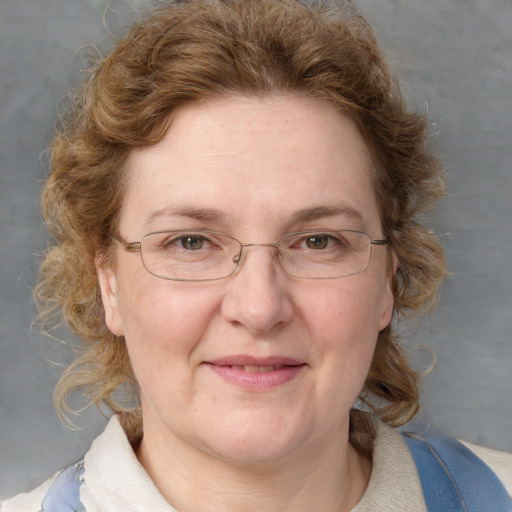 Joyful white adult female with medium  brown hair and blue eyes