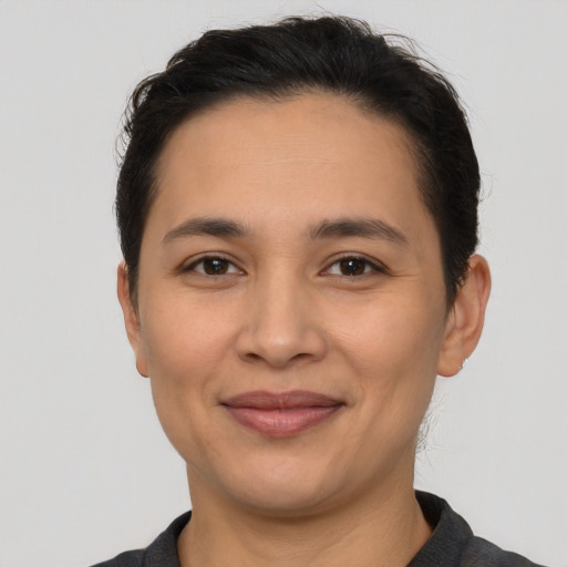 Joyful latino young-adult female with short  brown hair and brown eyes