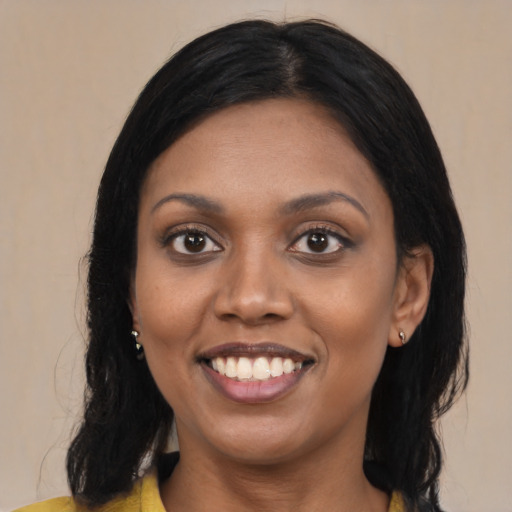 Joyful latino young-adult female with medium  black hair and brown eyes