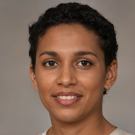 Joyful latino young-adult female with short  black hair and brown eyes