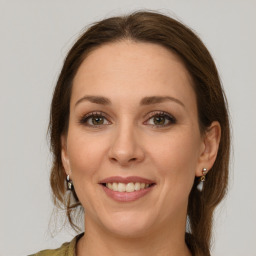 Joyful white young-adult female with medium  brown hair and grey eyes