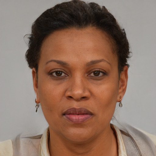 Joyful black adult female with short  brown hair and brown eyes