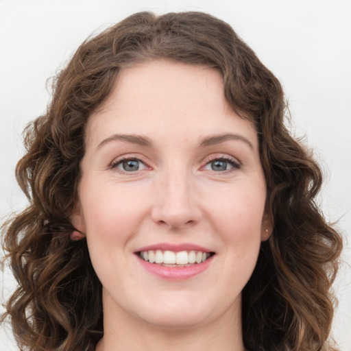 Joyful white young-adult female with long  brown hair and green eyes