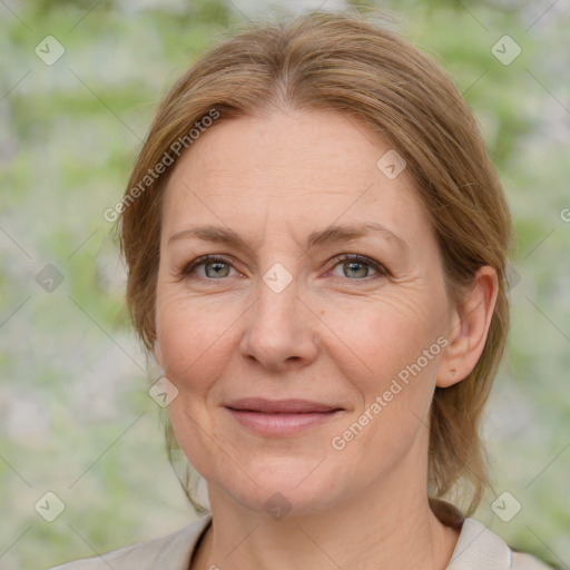 Joyful white adult female with medium  brown hair and blue eyes