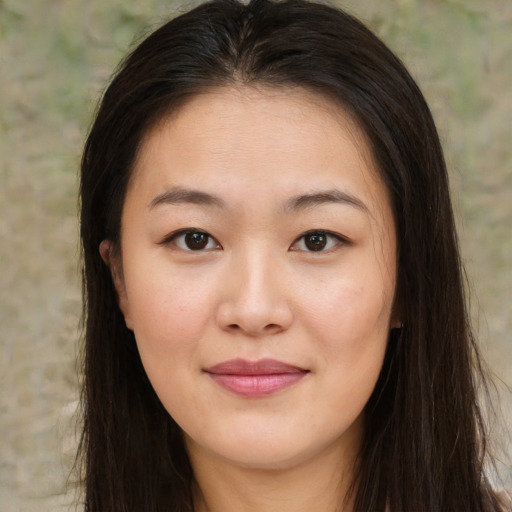 Joyful asian young-adult female with long  brown hair and brown eyes