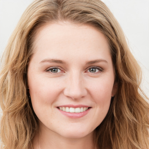 Joyful white young-adult female with long  brown hair and blue eyes