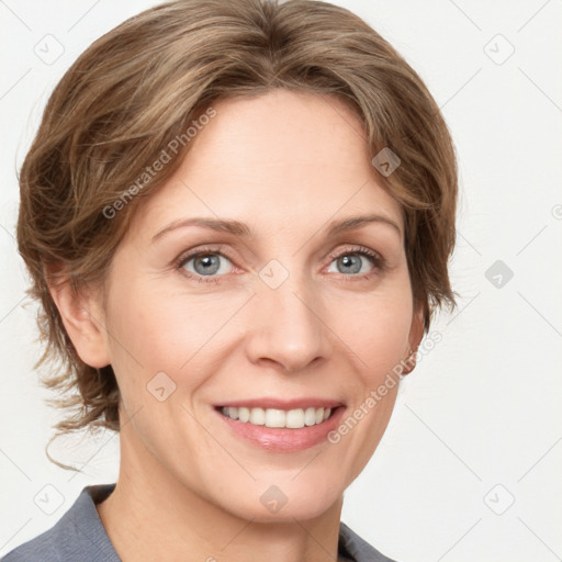 Joyful white adult female with medium  brown hair and blue eyes