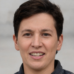 Joyful white adult male with short  brown hair and grey eyes