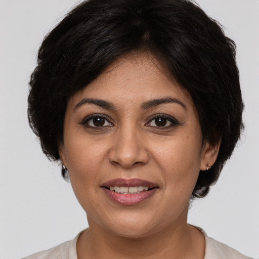 Joyful white adult female with medium  brown hair and brown eyes