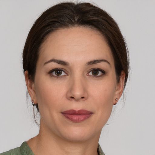 Joyful white young-adult female with medium  brown hair and grey eyes