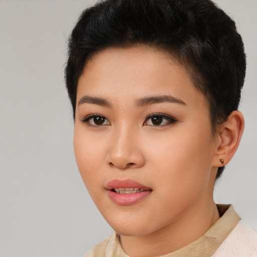 Joyful asian young-adult female with short  brown hair and brown eyes