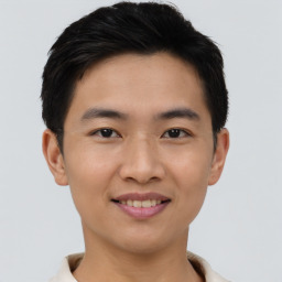 Joyful asian young-adult male with short  black hair and brown eyes