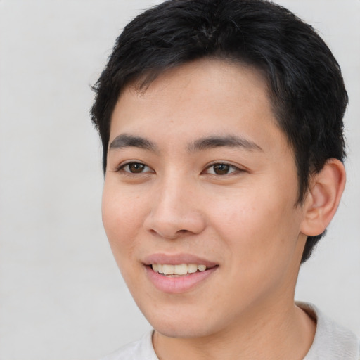 Joyful asian young-adult male with short  brown hair and brown eyes