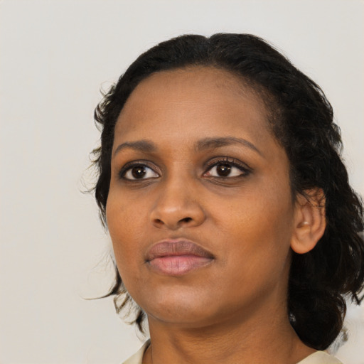 Joyful black young-adult female with medium  black hair and brown eyes