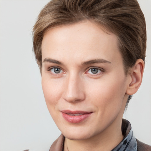 Joyful white young-adult female with medium  brown hair and grey eyes