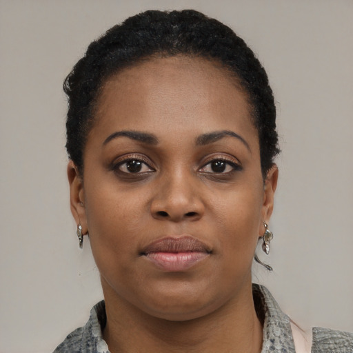 Joyful black young-adult female with short  black hair and brown eyes