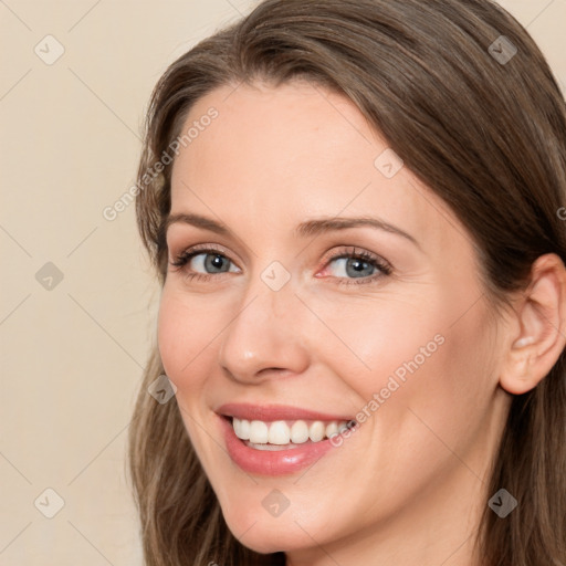 Joyful white young-adult female with long  brown hair and grey eyes