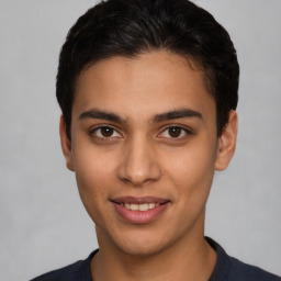 Joyful latino young-adult male with short  brown hair and brown eyes