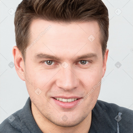 Joyful white young-adult male with short  brown hair and grey eyes