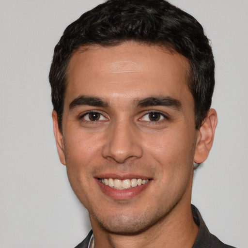 Joyful white young-adult male with short  black hair and brown eyes