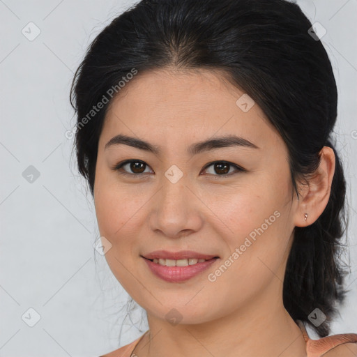 Joyful asian young-adult female with medium  brown hair and brown eyes