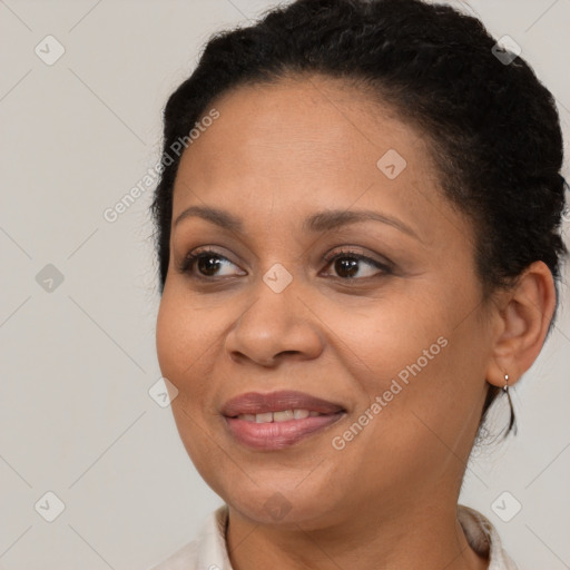 Joyful black adult female with short  brown hair and brown eyes