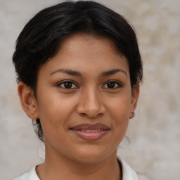 Joyful latino young-adult female with short  brown hair and brown eyes