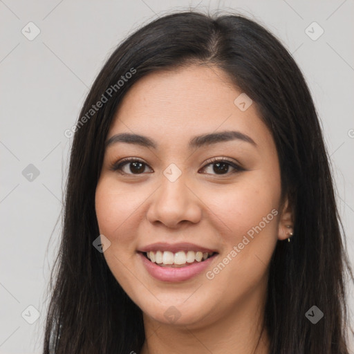 Joyful latino young-adult female with long  brown hair and brown eyes