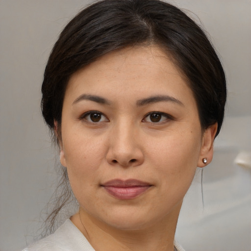 Joyful asian young-adult female with medium  brown hair and brown eyes